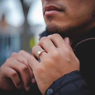 A man wearing a promise ring on his ring finger